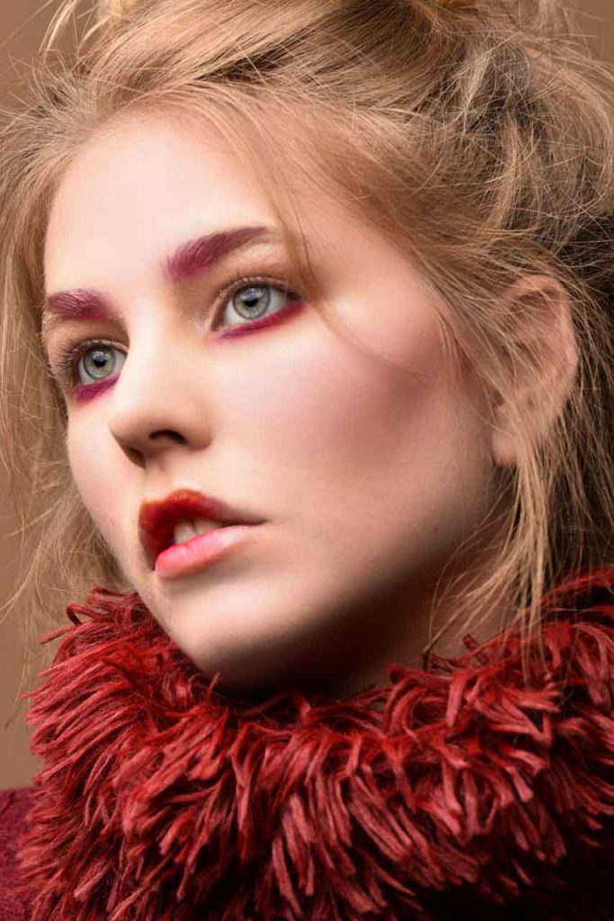 Model with red beauty makeup