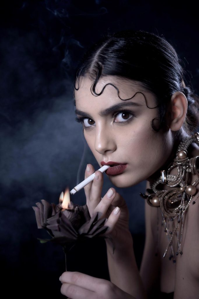A model lights a cigarette in an art image
