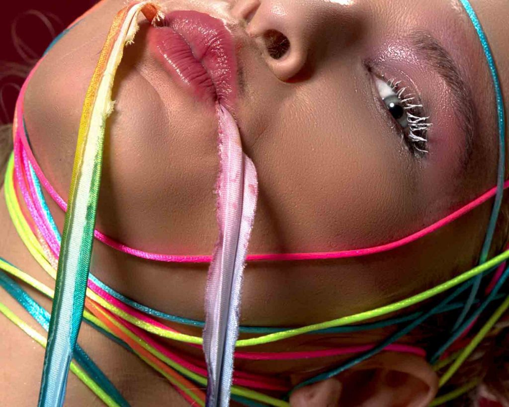make-up model holds strings in her mouth