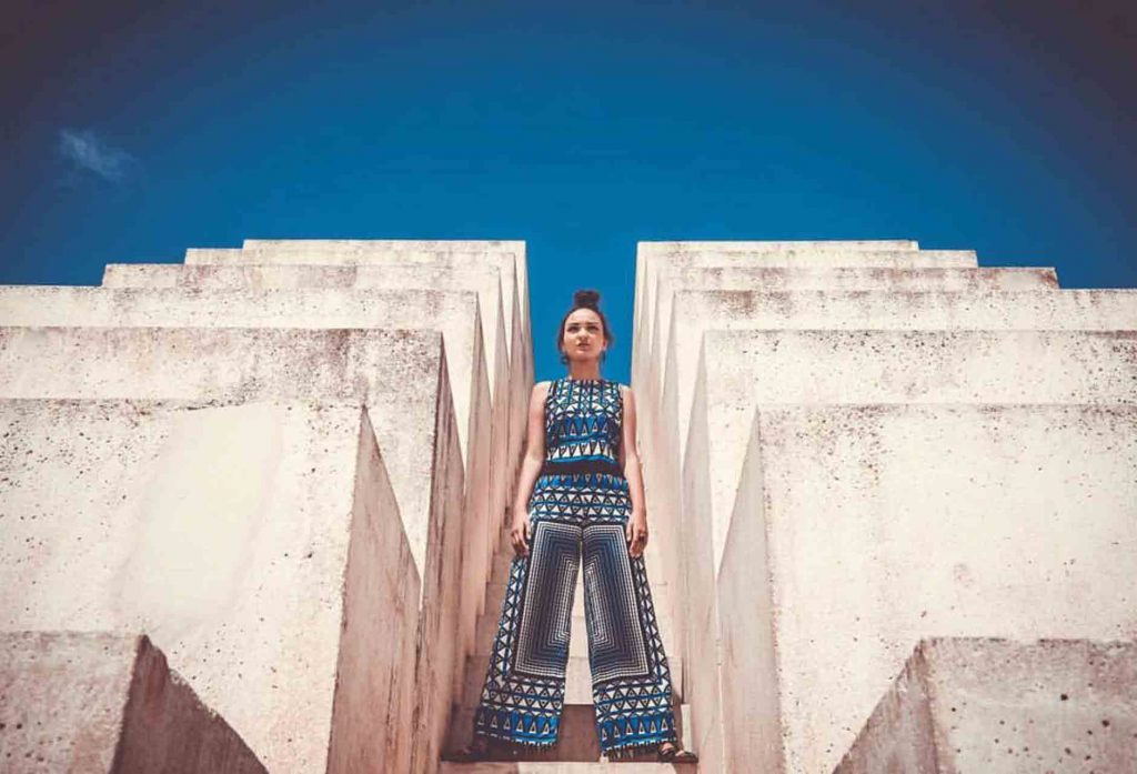 model stands on stairs from a fashion production
